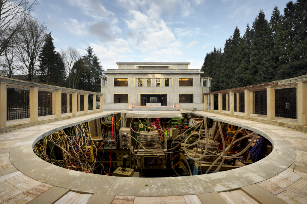 Paper collage. The Art Deco swimming pool of the Villa Empain in Brussels, its elegant facade visible in the background, with the water replaced by rows of computer servers.